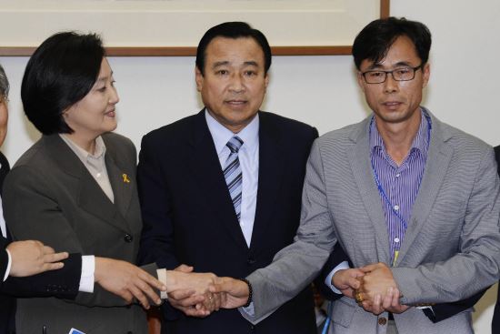 "새누리당 이완구·새정치민주연합 박영선 원내대표가 29일 국회 운영위원장실에서 열린 여야-세월호 유가족 3자회동에 앞서 전명선 세월호 유가족 대책위원회 위원장과 악수를 하고 있다. 김지훈 기자"