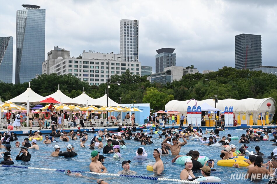 서울 낮 기온이 33도 안팎까지 오른 27일 서울 여의도 한강공원 수영장을 찾은 시민들이 물놀이를 즐기고 있다.